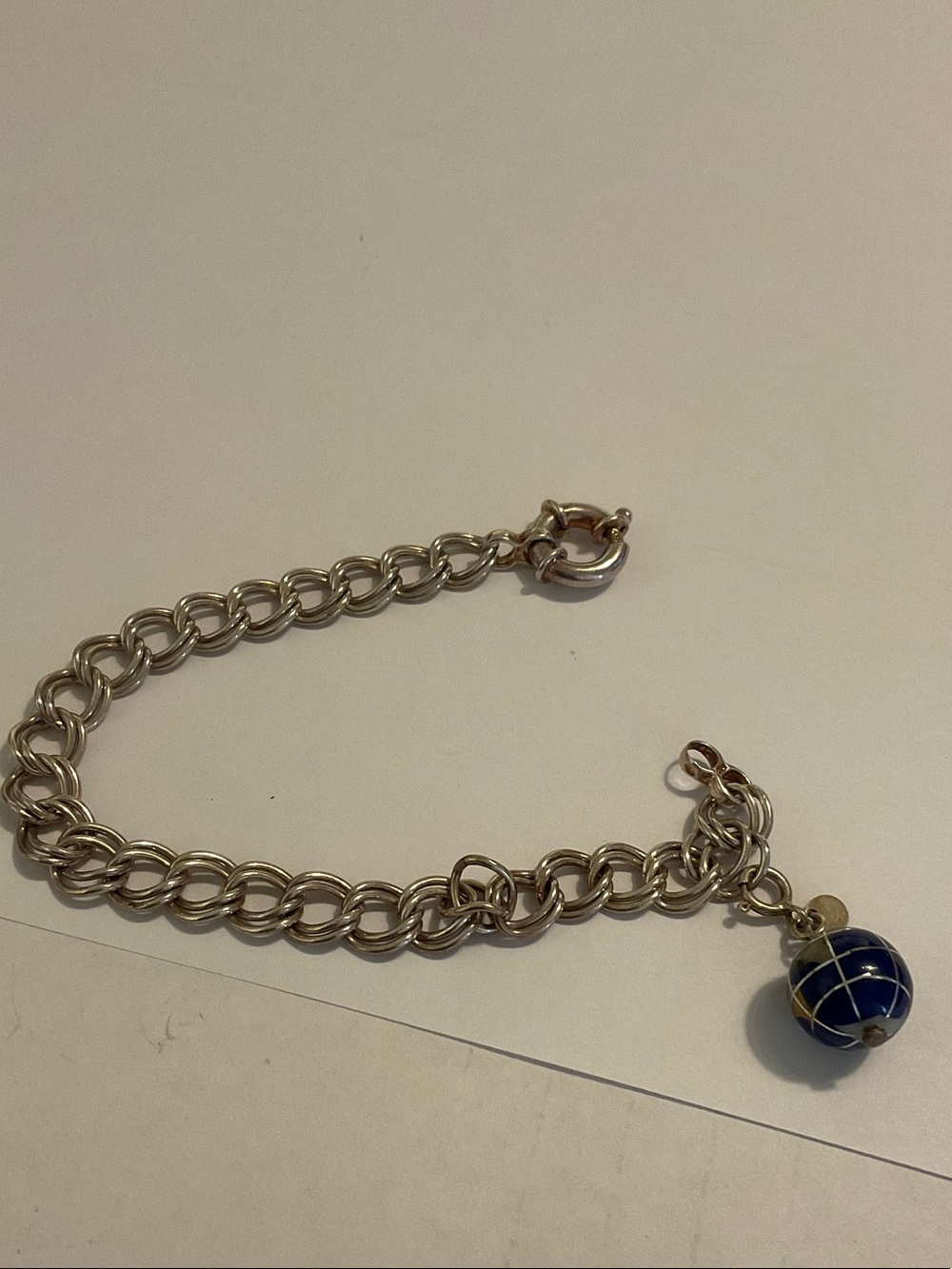 Sterling silver charm bracelet with world charm